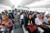 Asiatische Passagiere im ausgebuchten, grossen Linienflugzeug