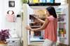 Frau vor Kühlschrank mit Lebensmitteln